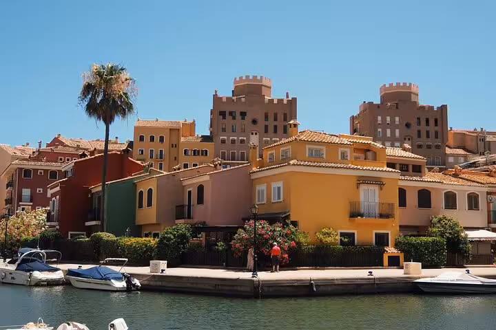 E-bike tour Valencia marina canal view with colorful waterfront houses and boats near the beaches