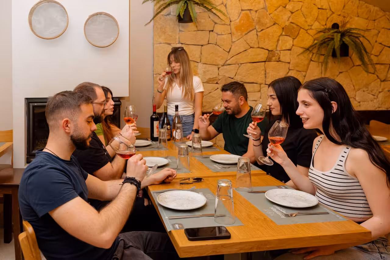 Guests enjoy Cretan wine tasting indoors after an eco bike full-day tour discovering authentic Crete villages