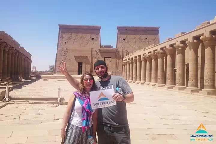 Travelers pose at Edfu Temple courtyard, part of 15 days 14 nights Holy Family Tour in Egypt package
