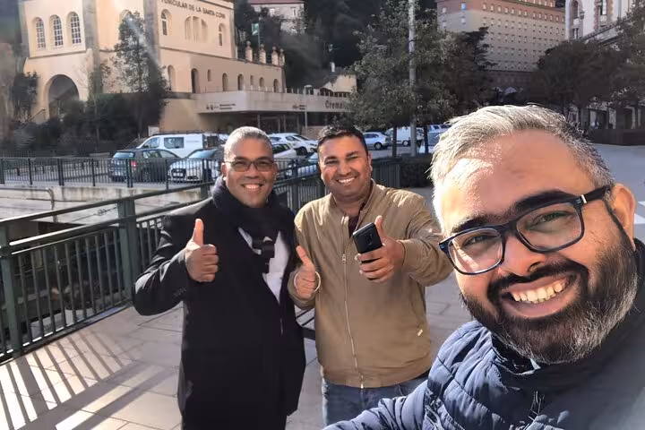 Happy riders give thumbs up on an Edinburgh Express 2 hour highlights ride with city sights behind