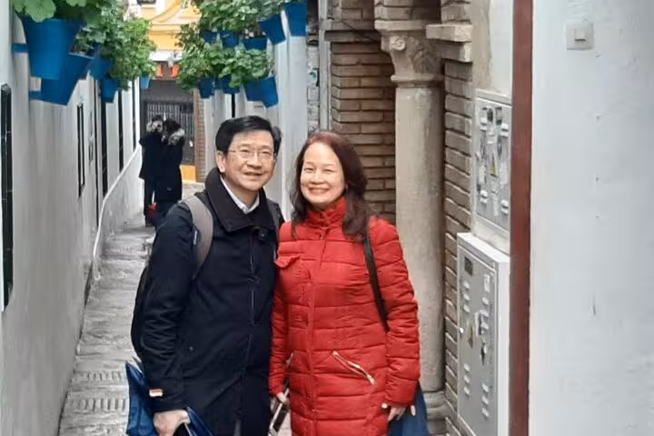 Guests pose in a charming Old Town lane on the Edinburgh Express 2 hour highlights ride city tour