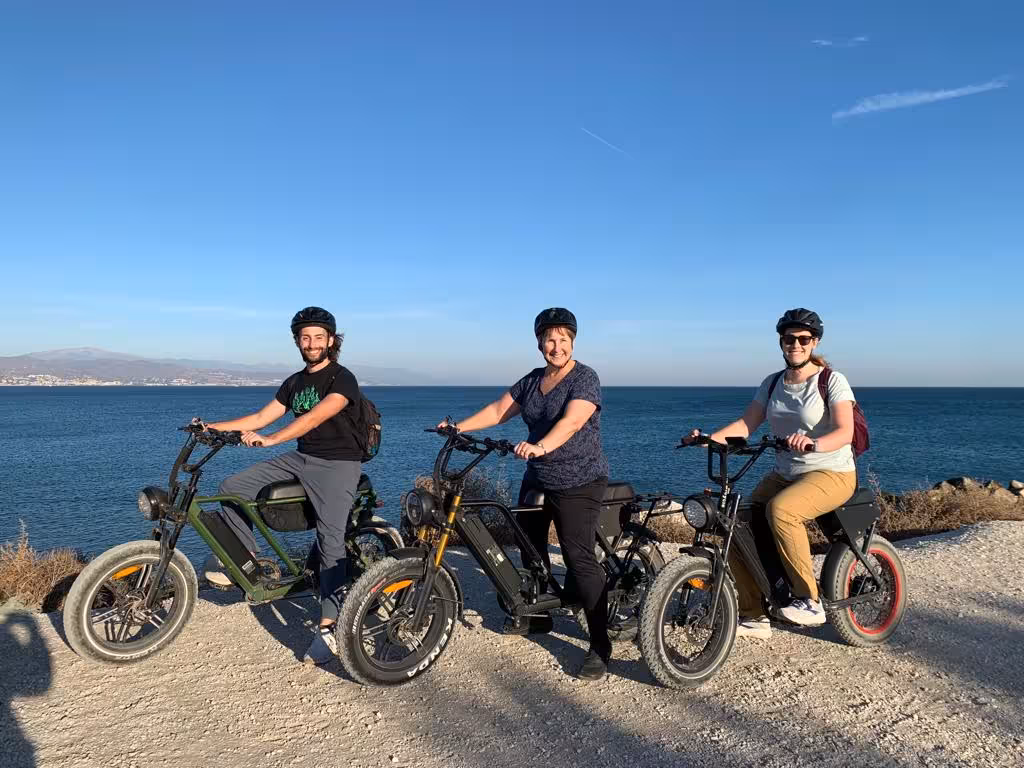 Group on e-fat bikes at seaside viewpoint with ocean backdrop, ideal for 4-hour fat tire e-bike coastal ride