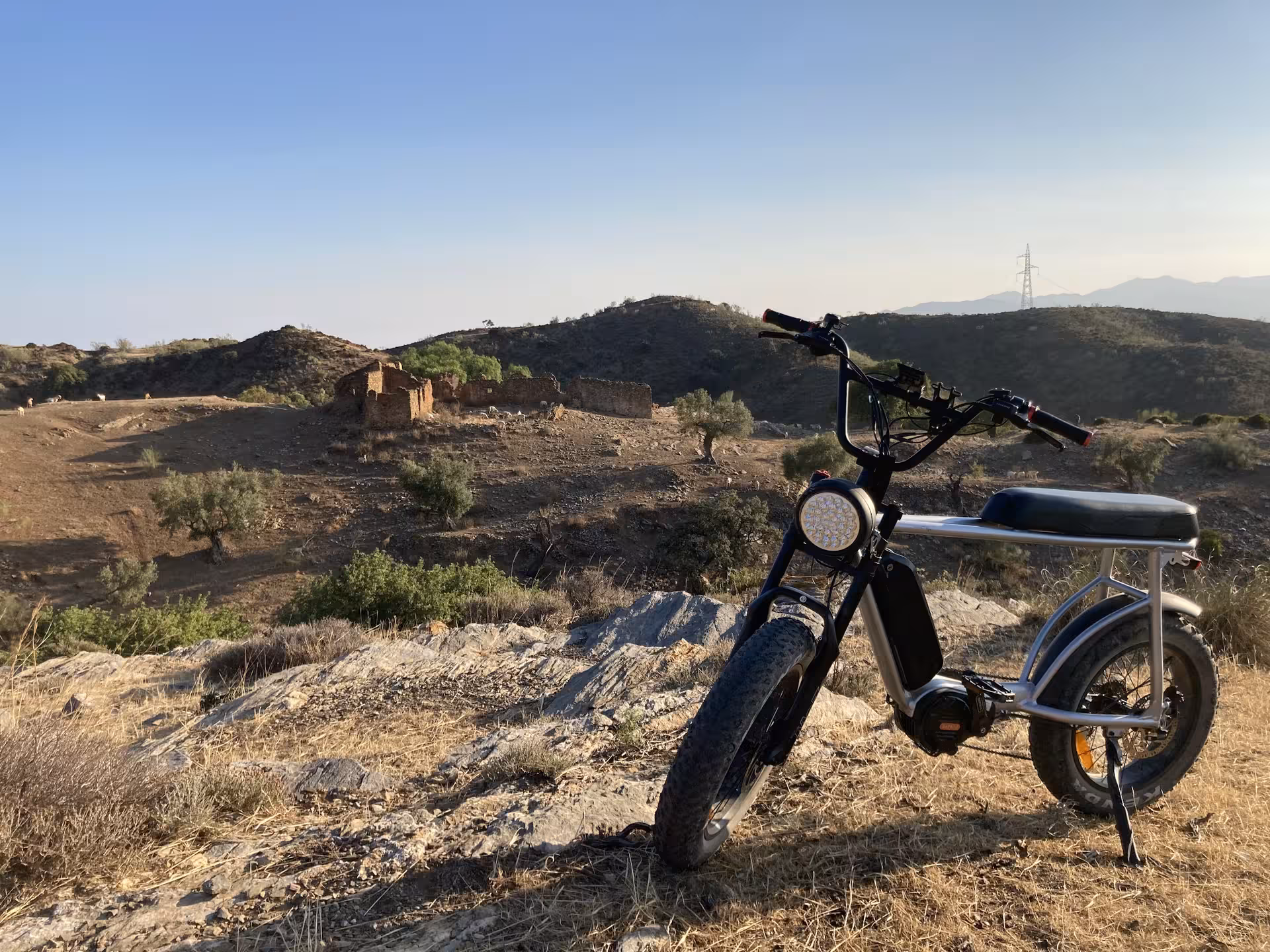 E-fat bike rental parked on rocky trail viewpoint, ideal for 4-hour ride with coastal and mountain views