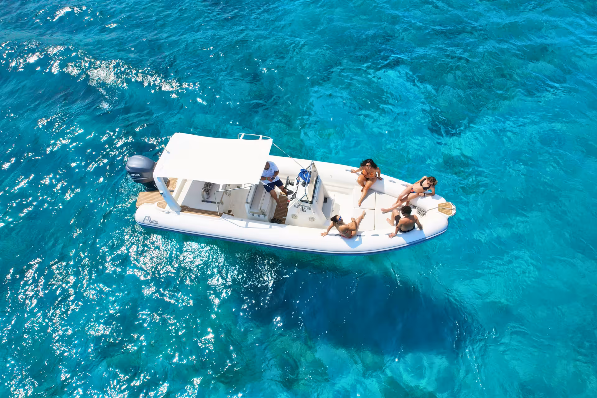 Aerial view of dinghy in crystal-clear water during Egadi Islands private tour, Favignana and Levanzo excursion from Trapani