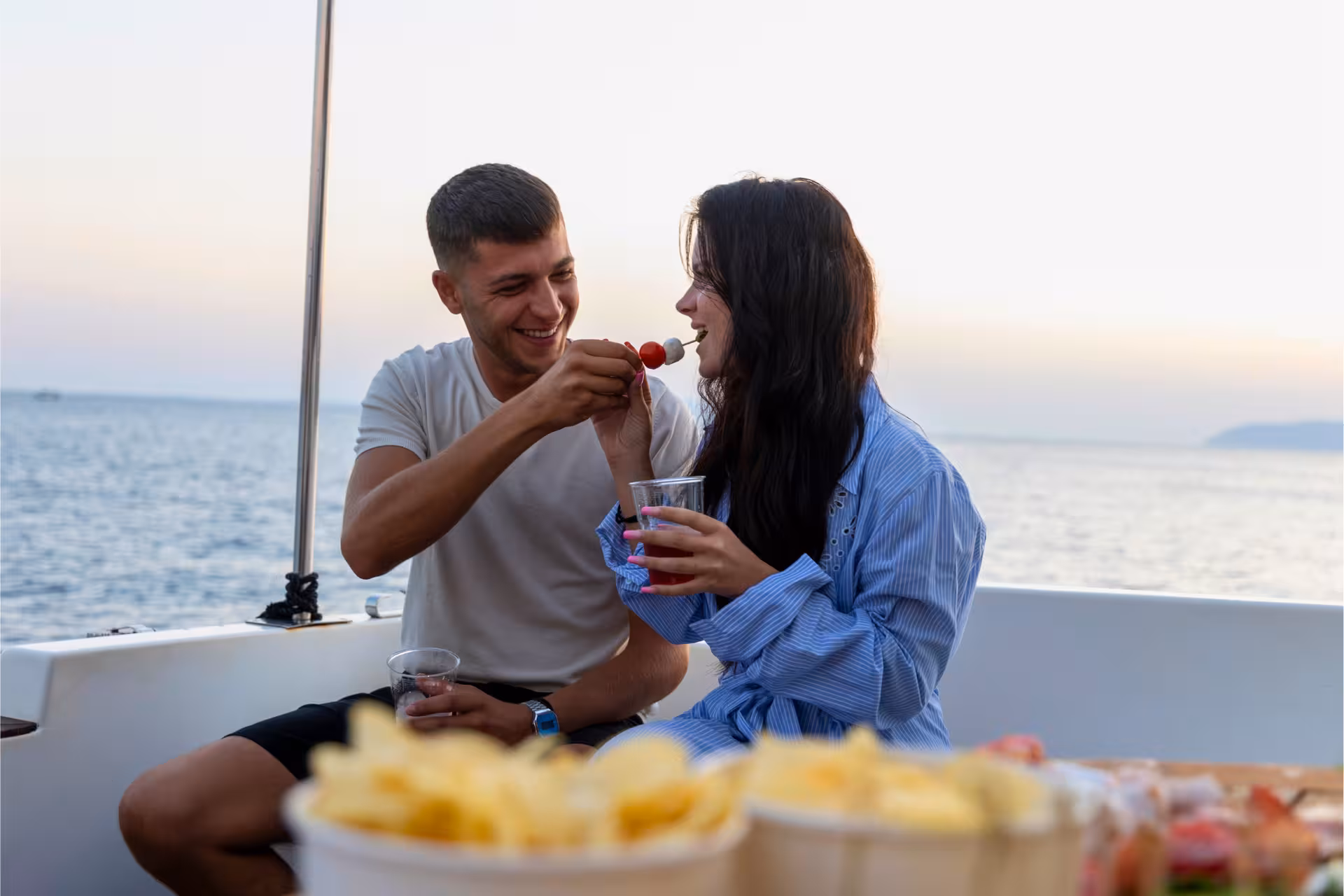 Couple enjoying aperitif and snacks onboard private boat tour from Trapani to Favignana and Levanzo with lunch