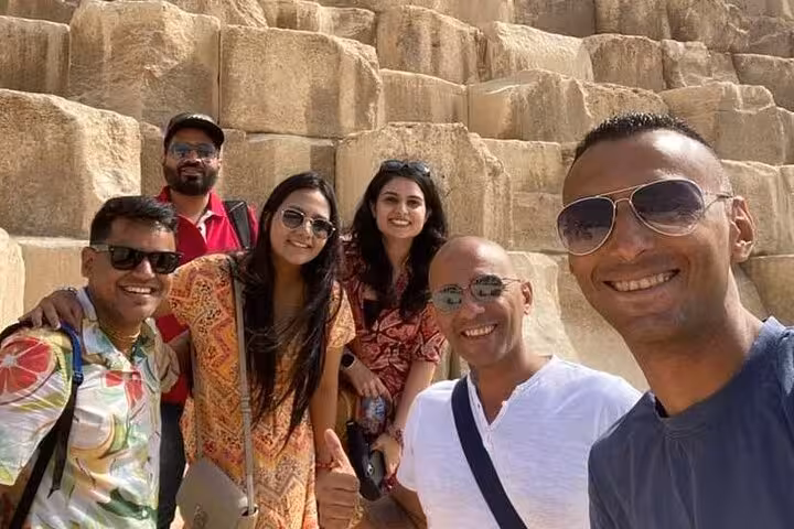 Group of travelers enjoying their Egypt tour at the Great Pyramid, part of an 11-day all-inclusive Nile cruise package.