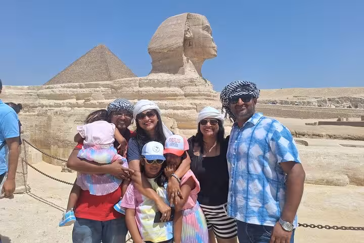 Family enjoying a sunny day at the Sphinx and Pyramids, highlighting unique Egypt tour with Nile cruise.