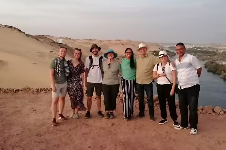 Tour group photo on Sahara desert overlook above the Nile near Aswan, part of 14-day Egypt bus adventure
