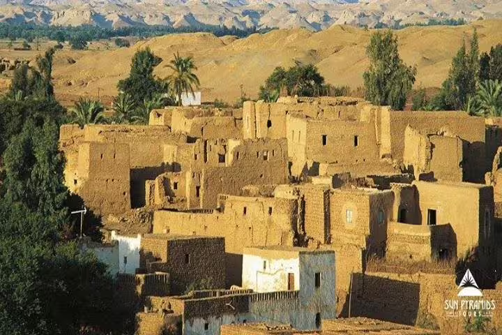 Traditional mudbrick village in Egypt’s Western Desert oasis, scenic stop on 15-day Pyramids Luxor Aswan tour