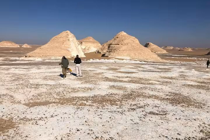 Travelers explore Egypt White Desert chalk formations on a private 2-day Black and White Desert camping tour
