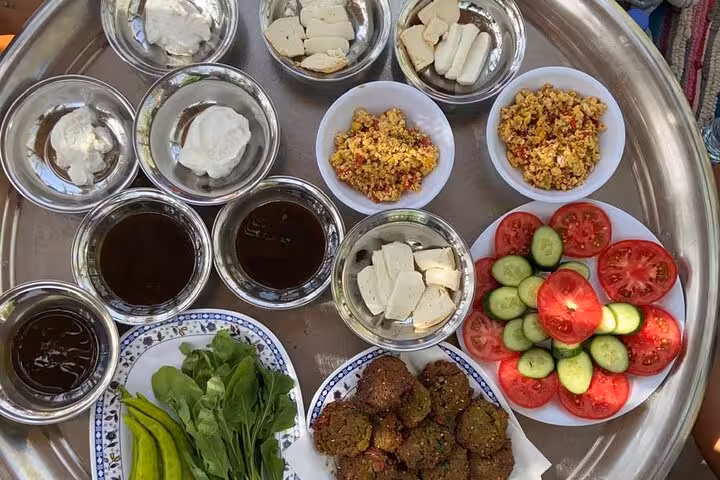Egyptian farm breakfast tray in Dahshur countryside with local cheese, falafel, salad and herbal tea