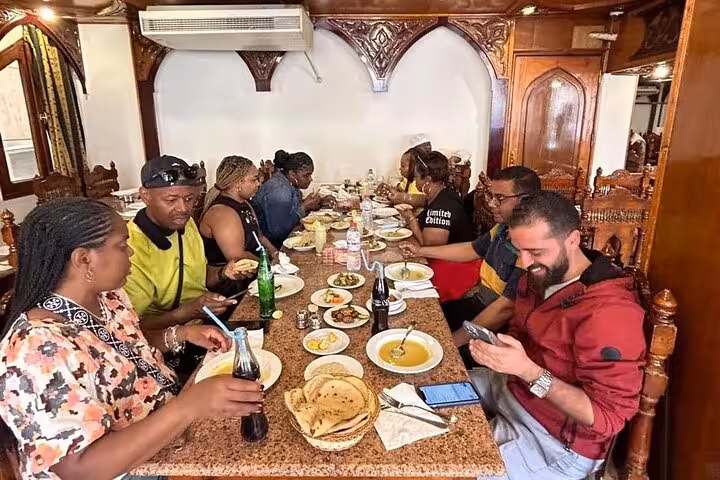Group dining at a local Cairo restaurant with Egyptian soups, bread and tea on a traditional food tour