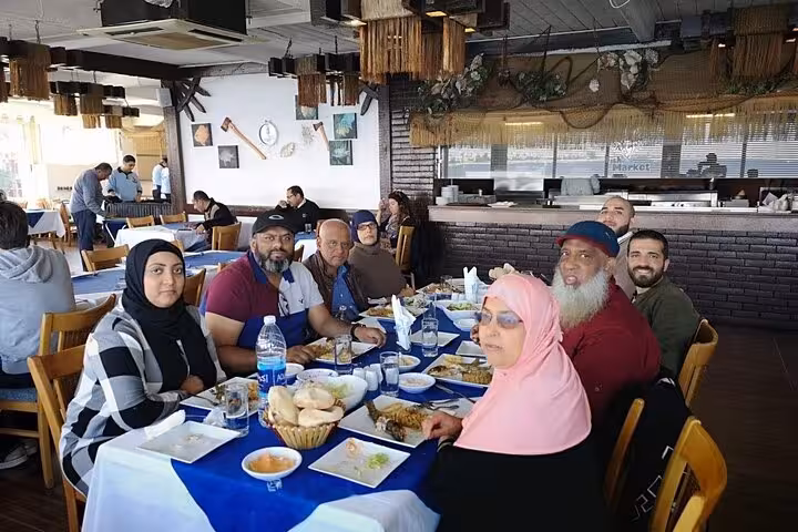 Group enjoying traditional Egyptian lunch with bread and mezze at a local restaurant on a Cairo food tour