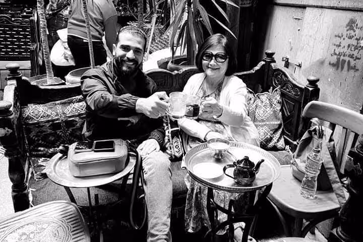 Guide and guest toast mint tea at a traditional Egyptian café during an Eat Like a Local food tour