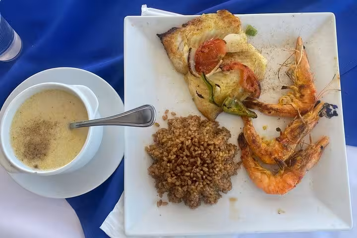 Experience authentic Egyptian cuisine with grilled shrimp, vegetables, and wheat pilaf from a pyramid tour meal.