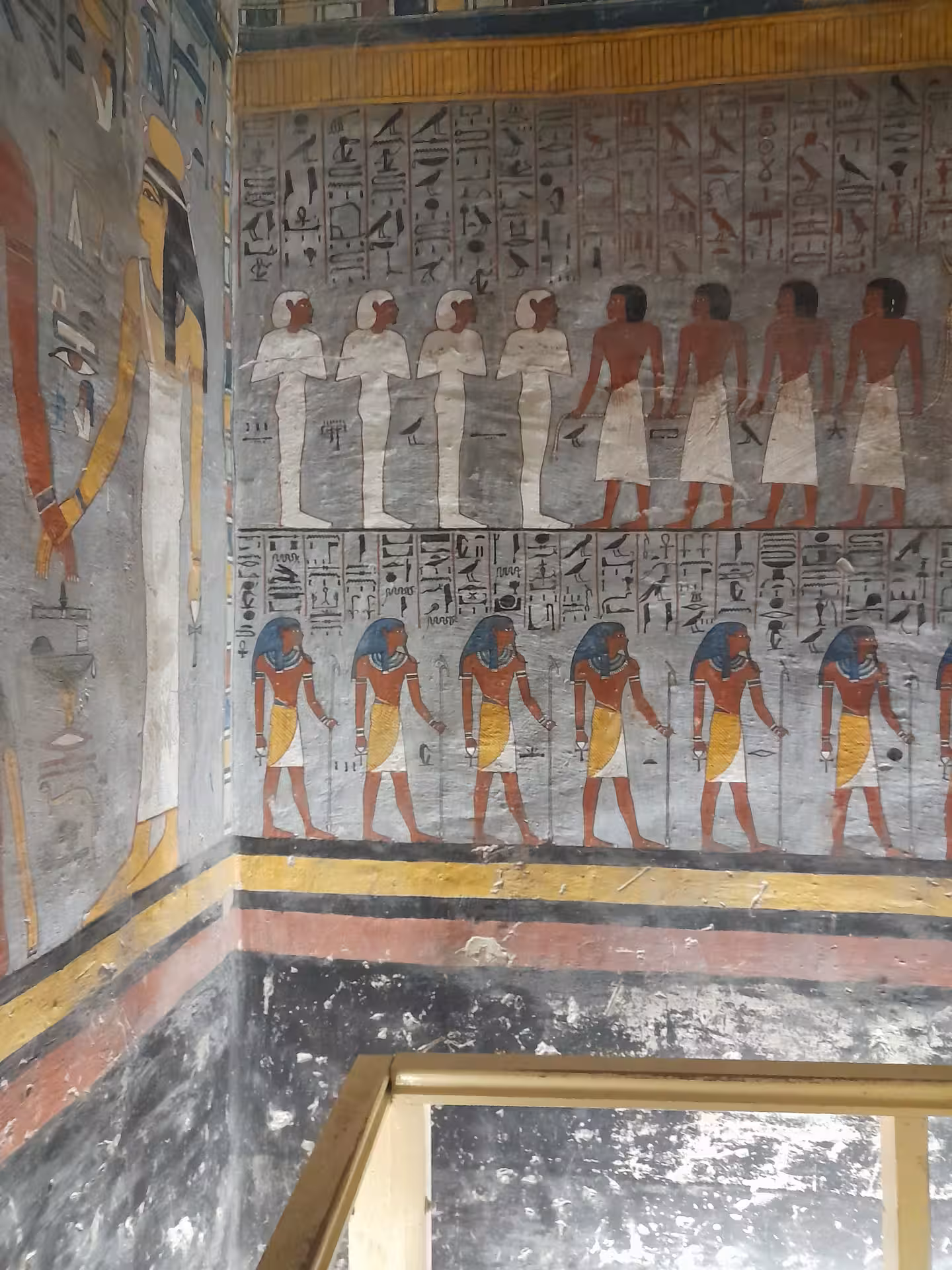 Discover vibrant Egyptian hieroglyphs and murals depicting ancient deities and figures in vivid colors.
