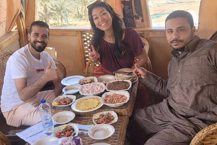 Guests enjoying traditional Egyptian mezze and tea in a cozy hut, authentic eat like a local food tour