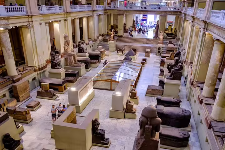 Grand hall inside the Egyptian Museum Cairo with statues and sarcophagi on a private half-day guided tour