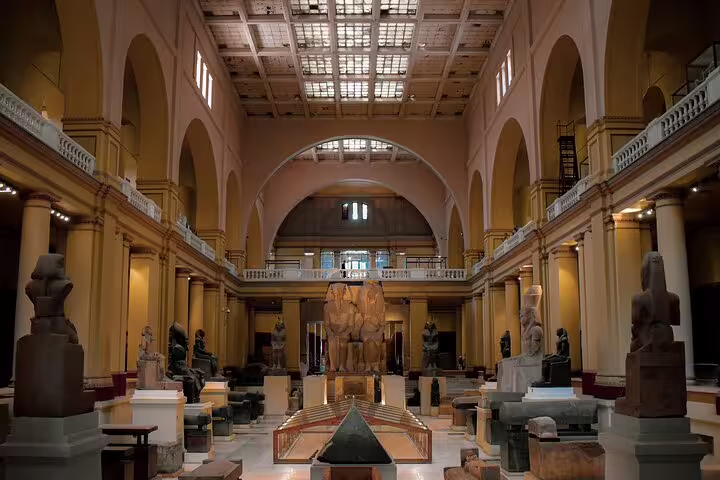 Grand hall inside the Egyptian Museum Cairo with ancient statues and sarcophagi on a Cairo day tour