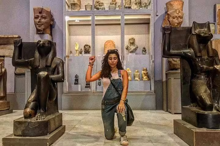 Visitor inside the Egyptian Museum Cairo with ancient statues, included in luxury 8-day Cairo and Nile cruise