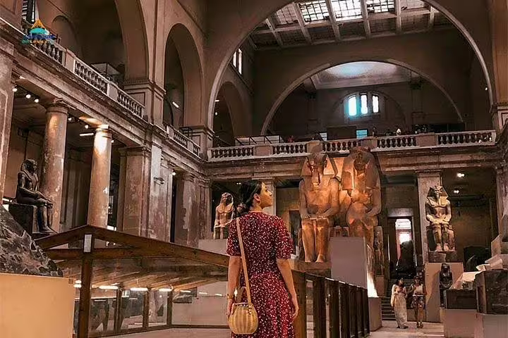 Traveler exploring Egyptian Museum Cairo galleries with pharaoh statues, highlight of a 5 day Cairo vacation