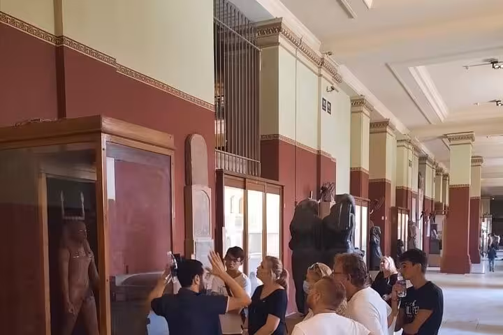 Travelers touring Egyptian Museum galleries in Cairo on a private full-day trip from Giza Pyramids to felucca