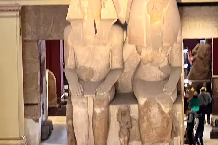 Colossal seated pharaoh statues inside the Egyptian Museum, Cairo stop on Pyramids of Giza day tour