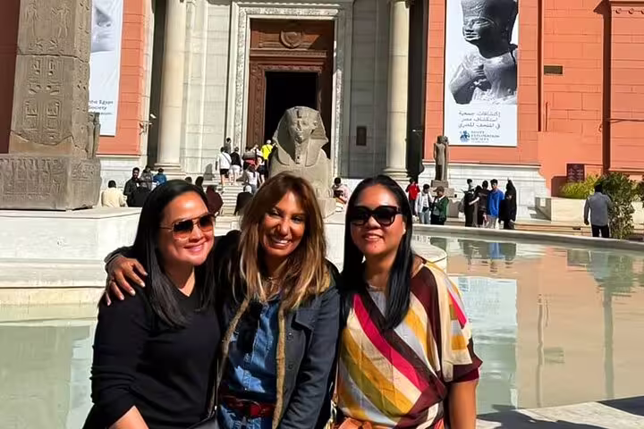 Happy travelers with private guide outside the Egyptian Museum Cairo on a half-day guided tour