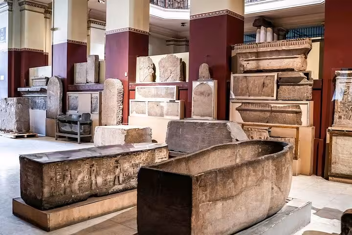 Ancient sarcophagi and stone artifacts inside the Egyptian Museum Cairo on Hurghada to Cairo museum tour