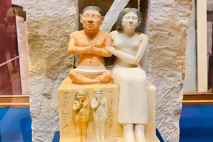 Seated ancient Egyptian couple statue in Egyptian Museum Cairo, stop on Pyramids of Giza Cairo bus tour