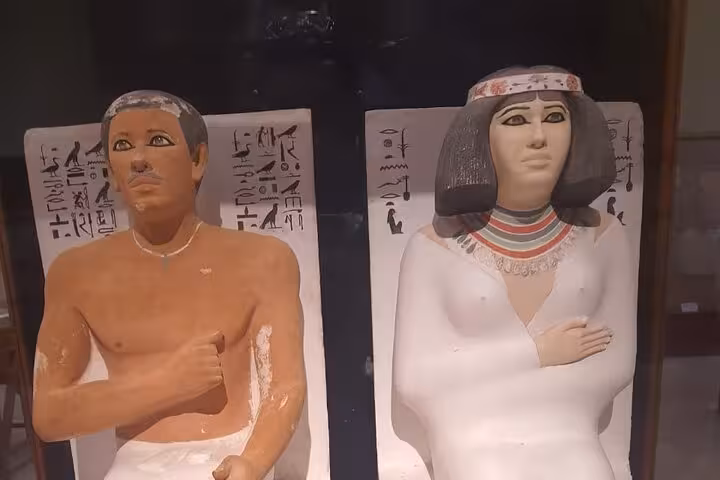 Painted ancient Egyptian tomb statues with hieroglyphs at the Egyptian Museum Cairo on Giza tour