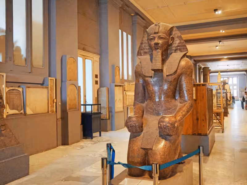 Ancient Egyptian pharaoh statue inside the Egyptian Museum in Cairo, featured on the Golden Cairo guided tour