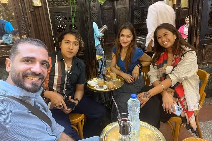 Travelers enjoy Egyptian tea and street café vibes on an Eat Like a Local Cairo food and tea tour