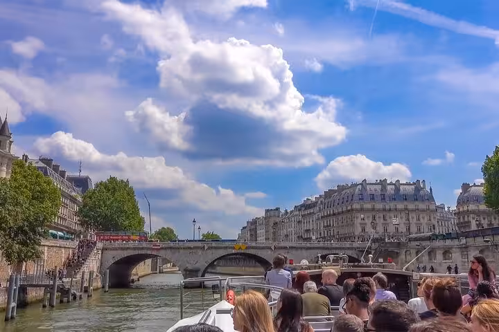Private Seine cruise passing historic Paris bridges, part of luxury Eiffel Tower lunch and Louvre guided tour