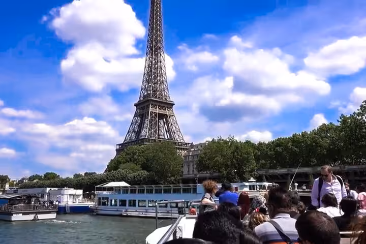 Eiffel Tower view from Seine River cruise boat on private luxury Paris tour with lunch and Louvre visit