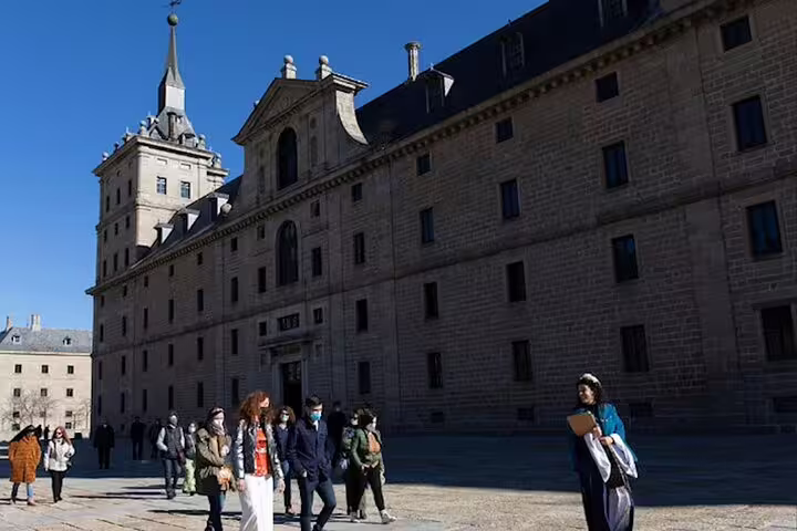 Visitors in the courtyard of El Escorial Monastery on a private minivan day trip from Madrid to Segovia