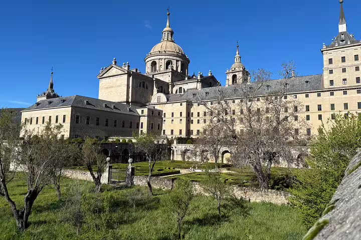 El Escorial Monastery exterior and gardens on a private minivan tour from Madrid, clear blue sky