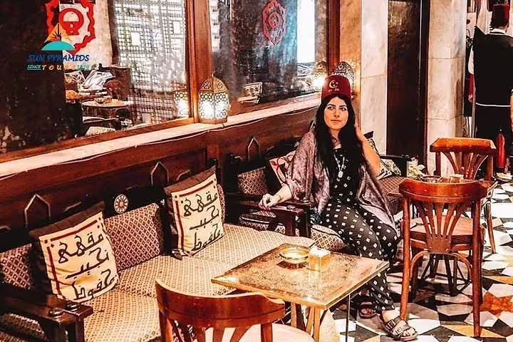 Traveler relaxing at El-Fishawy Café in Khan El Khalili after exploring historic El-Moez Street, Cairo