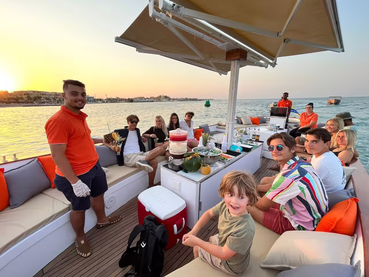 Group enjoys private yacht in El Gouna lagoon at sunset with refreshments, ideal city tour and boat trip