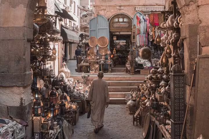 Historic Cairo bazaar alley near El-Moez Street with brassware and lantern shops on a 4-hour tour