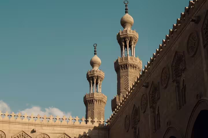 Minarets and carved stone walls along El-Moez Street in Islamic Cairo near Khan El Khalili Bazaar