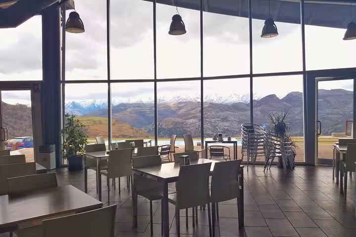 Panoramic view from El Soplao Cave restaurant with snow-capped mountains, offering a scenic dining experience.