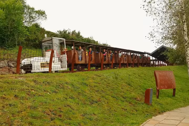 Tourist train at El Soplao Cave, transporting visitors through picturesque landscapes in Cantabria, Spain.