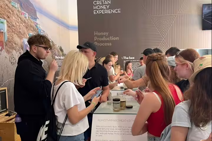 Visitors enjoying honey tasting at Cretan Honey Experience on the Private Tour Elafonisi Beach with local delights.