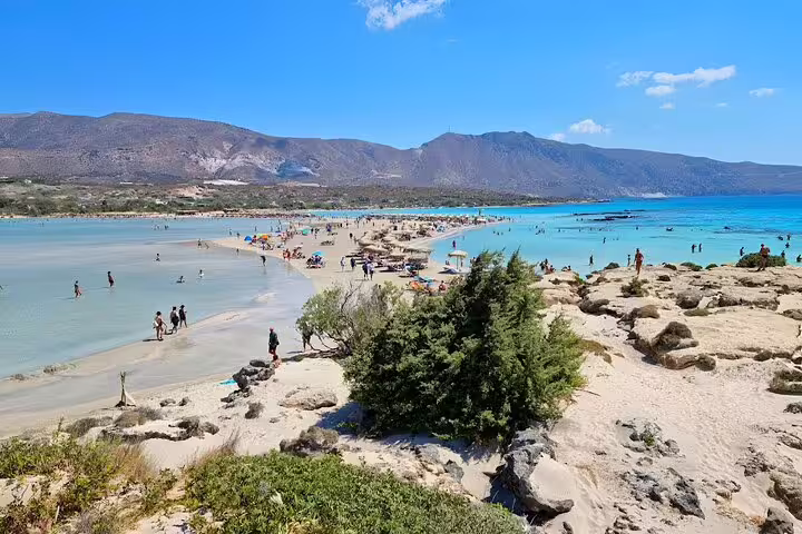 Scenic view of Elafonisi Beach's turquoise waters and rocky landscapes, ideal for private tours and exploration.