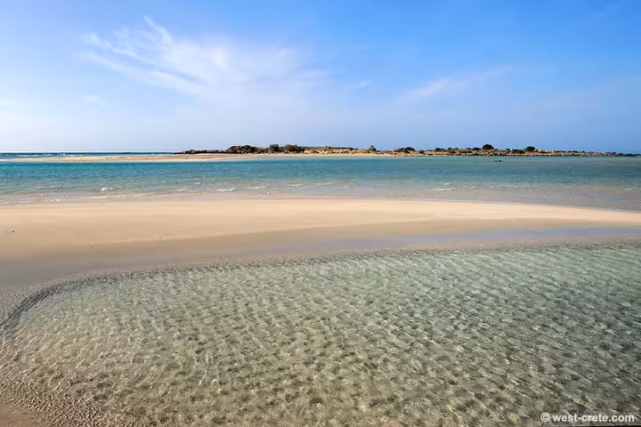 Shallow crystal-clear lagoon and sandbar at Elafonissi Beach, Crete, featured on Rethimno day tour