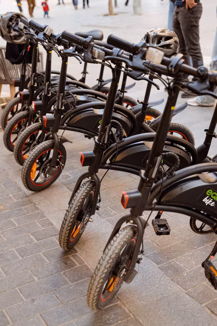 Row of rental electric bikes and helmets ready for an all-inclusive 3-day guided tour with 2-night stay