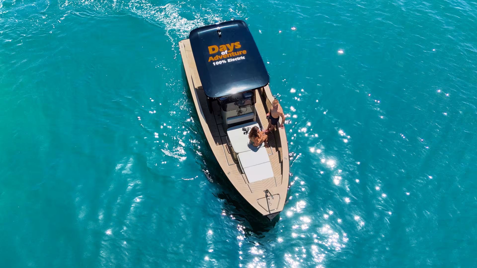 Aerial view of a 100% electric private tour boat on turquoise waters near Ponta da Piedade Lagos Algarve