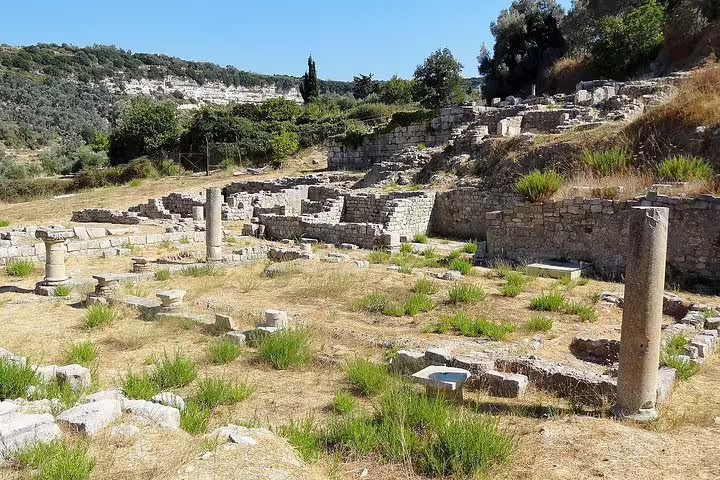 Ancient ruins of Eleftherna with scattered stone columns and lush greenery in the Rethymno countryside.