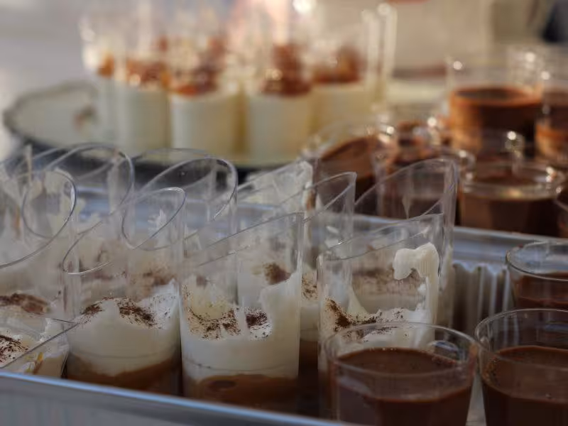 Elegant dessert buffet with layered chocolate and cream cups prepared for a private event catering experience